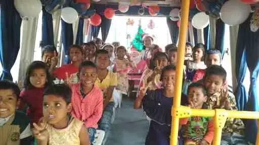 Children engaged in interactive learning inside Education on Wheels bus